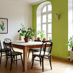 **

>A bright, airy living room in a renovated "Altbau" apartment. Walls are painted in a soft, natural off-white Kalkfarbe (lime paint). Sunlight streams through the windows, illuminating a refinished antique wooden table surrounded by upcycled chairs with colorful cushions. Potted plants (like ivy and snake plants) are placed throughout the room. The overall aesthetic is minimalist and eco-friendly.

**